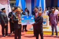 Foto. Bupati Kabupaten Manokwari Hermus Indou saat menyerahkan bantuan secara simbolis kepada salah satu petani.